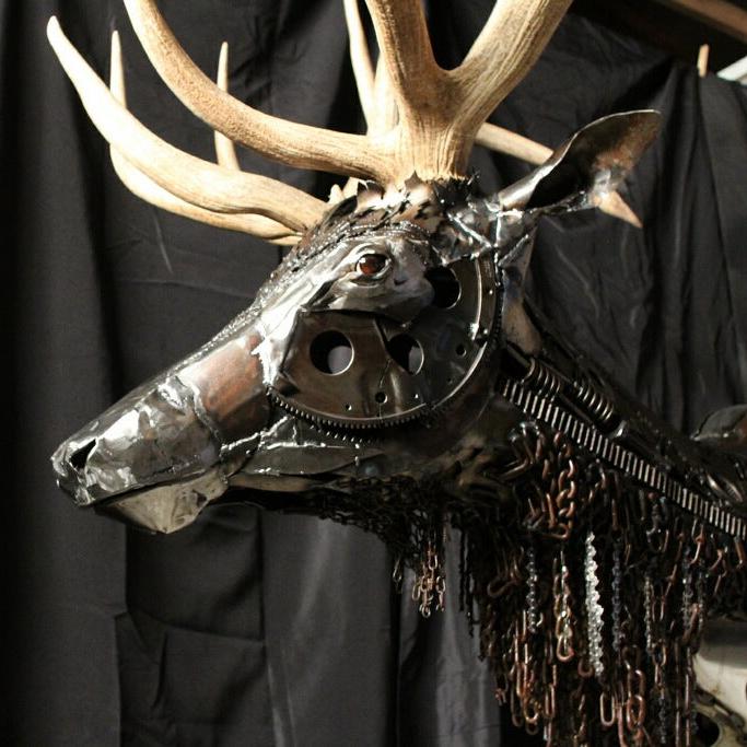 Elk head sculpture with gears, sheet metal, tire chains, taxidermy eyes, real antlers that are removable.